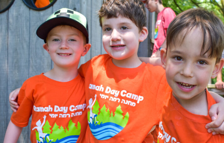 Three boys in orange camp ramah day camp shirts.