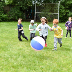 A group of boys running after a ball.