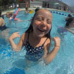 A girl swimming in a pool .