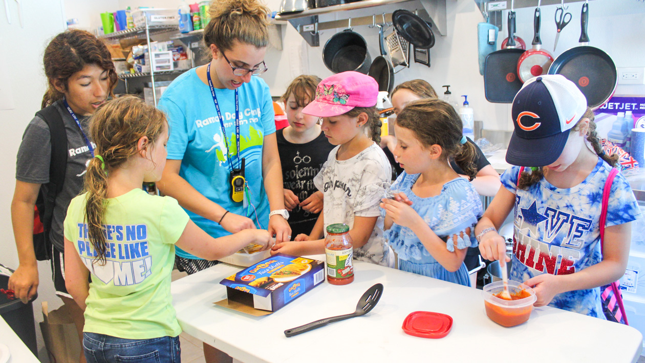 A group of kids inside doing a science experiment.