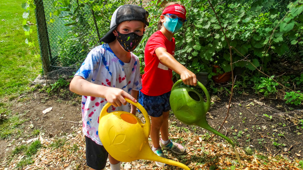 Boys watering flowers.