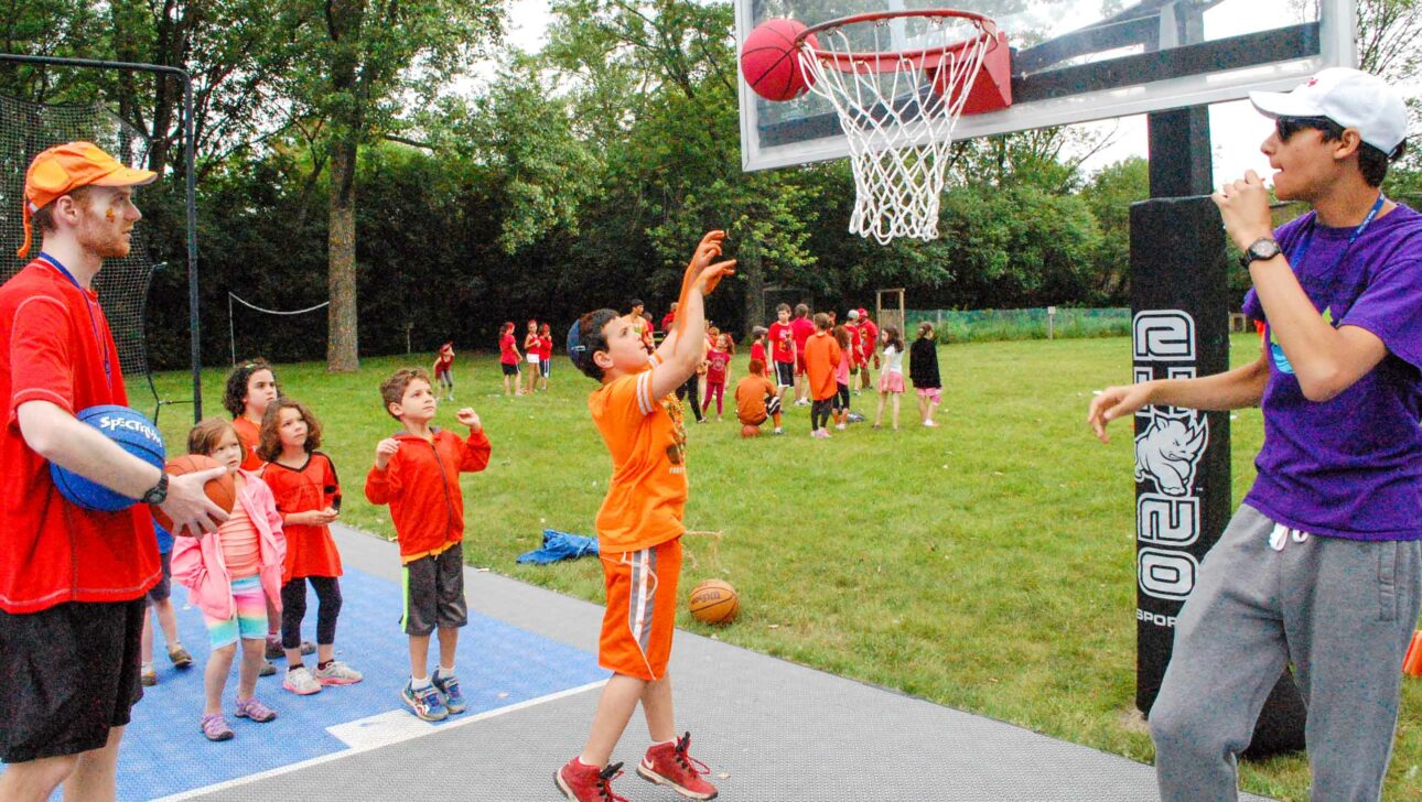 A boy shooting a basketball.